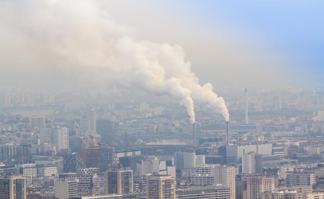 Air pollution by smoke coming out of two factory chimneys, Paris, France